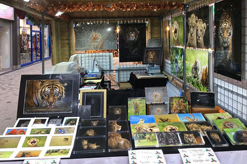 wildlife printed products by Ashley Vincent on display at an indoor Christmas event