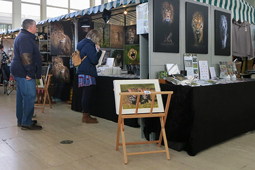 customers browsing at Ashley Vincent's picture display stand at the Milton Keynes March 2020 event