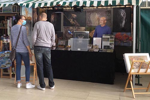 customers engaging with wildlife photographer ashley vincent at his stand at the Milton Keynes summer fair